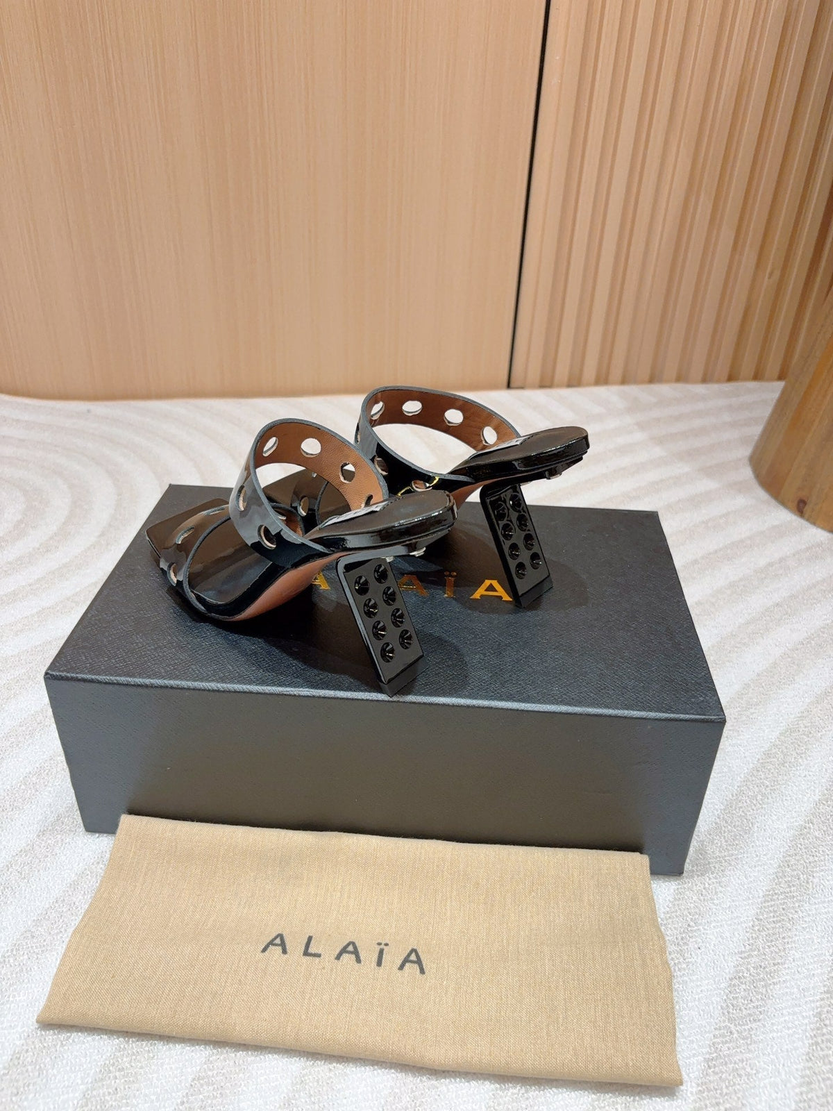 ALAIA TWO-STRAPS HIGH HEEL SANDALS IN BLACK PATENT LAMBSKIN