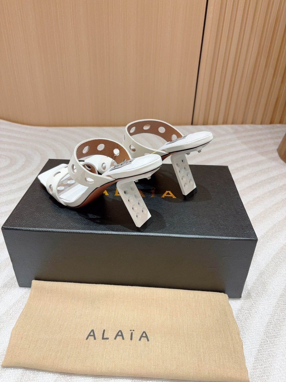 ALAIA TWO-STRAPS HIGH HEEL SANDALS IN WHITE PATENT LAMBSKIN