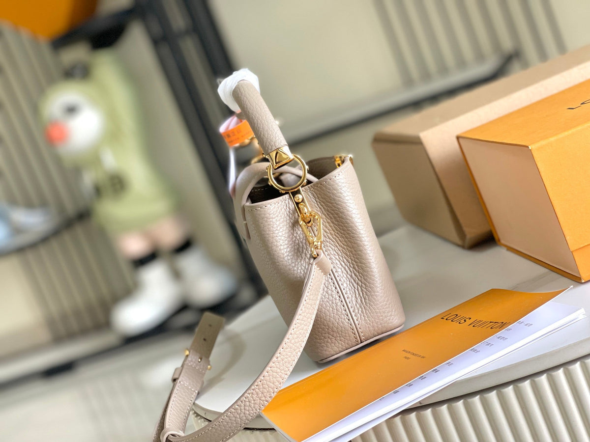CAPUCINES MINI 21 DARK BEIGE TAURILLON GOLD HARDWARE