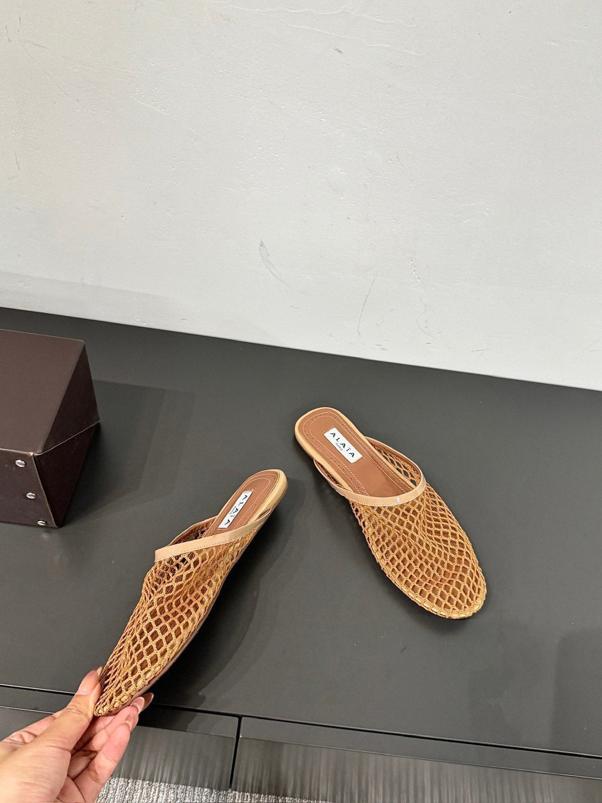 ALAIA FLAT MULES IN COPPER BROWN MESH FISHNET