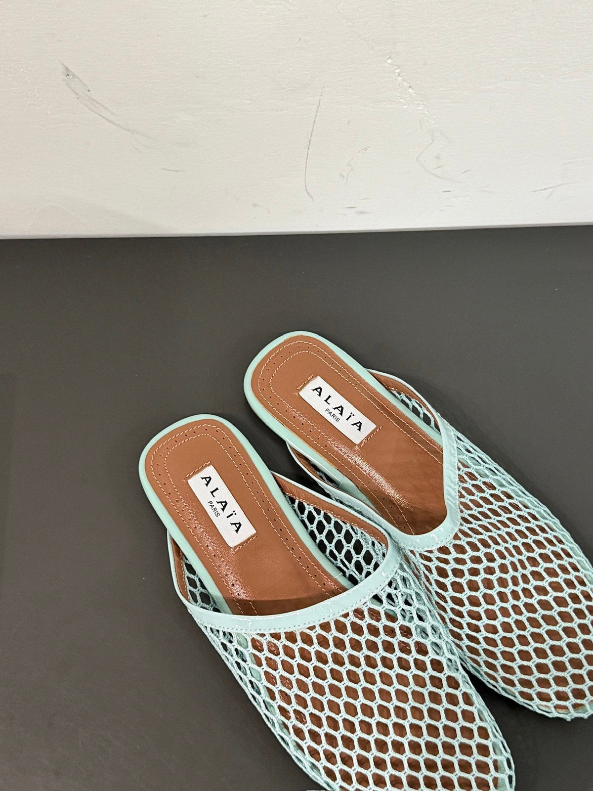 ALAIA FLAT MULES IN LIGHT BLUE MESH FISHNET