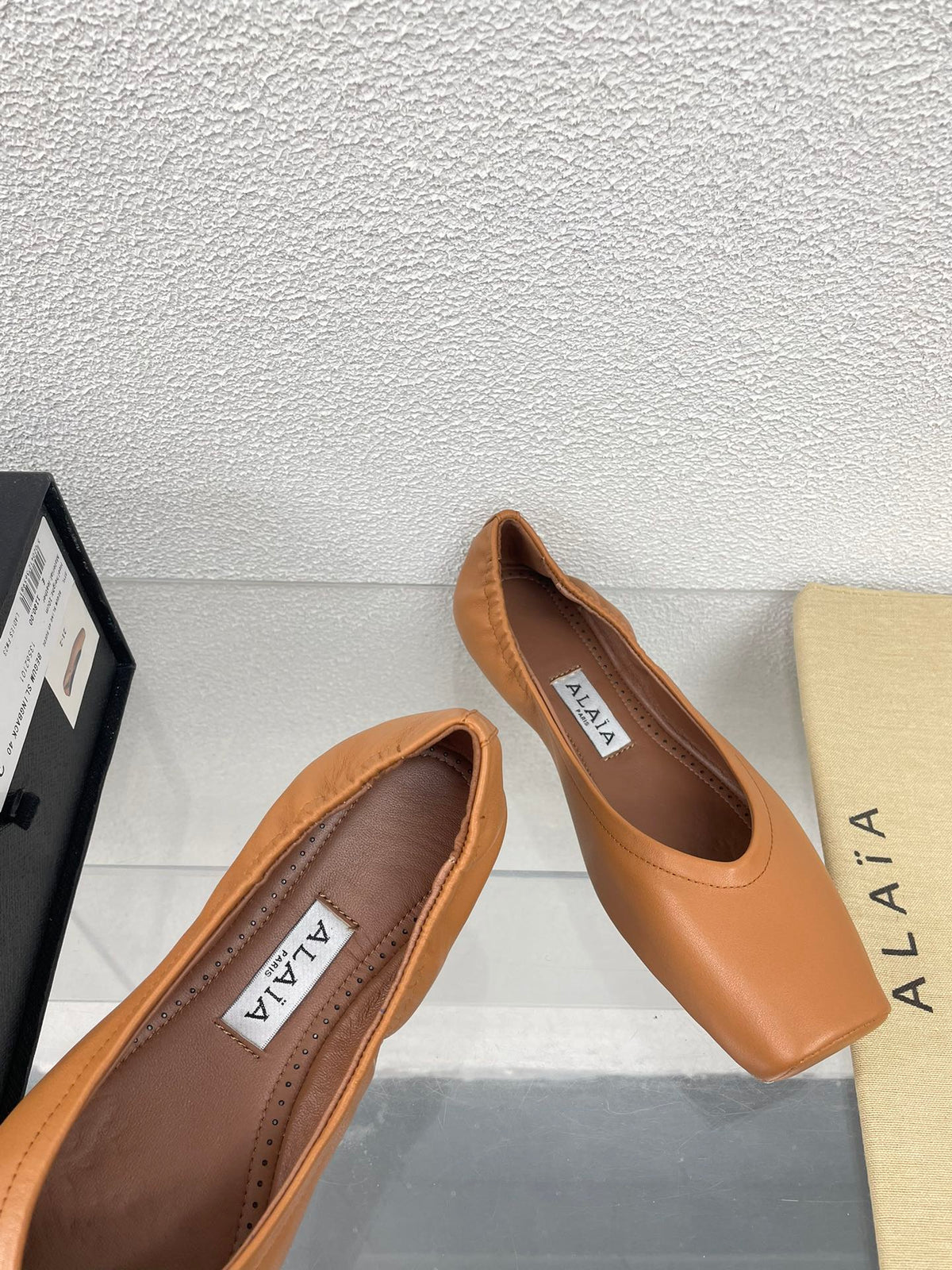 ALAIA BALLET FLATS IN COPPER BROWN CALFSKIN