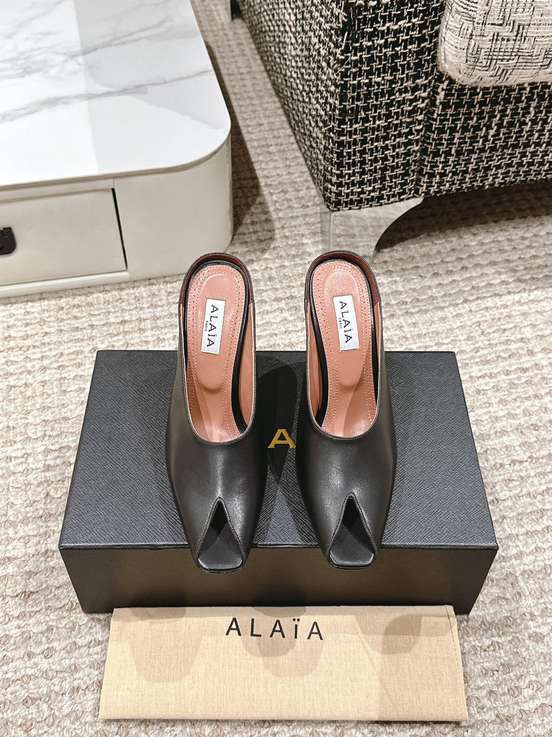ALAIA SPIKE JEWEL MULES IN BLACK CALFSKIN