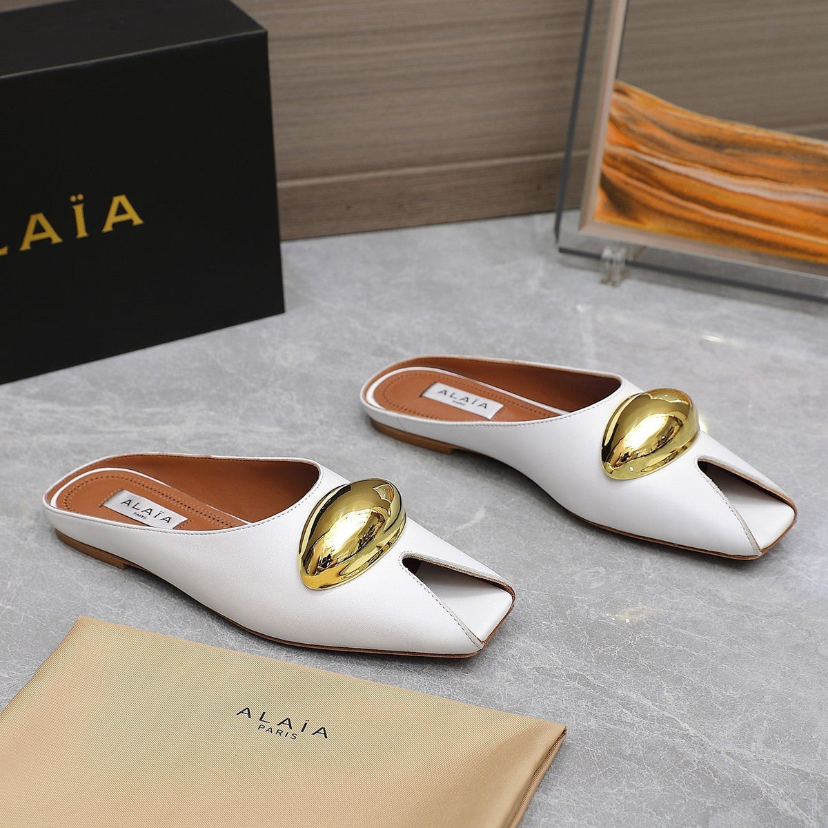 ALAIA FLAT MULE IN WHITE LAMBSKIN WITH GOLD HARDWARE