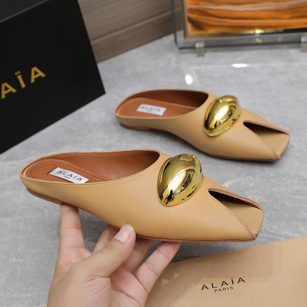 ALAIA FLAT MULE IN SEPIA TAN LAMBSKIN WITH GOLD HARDWARE