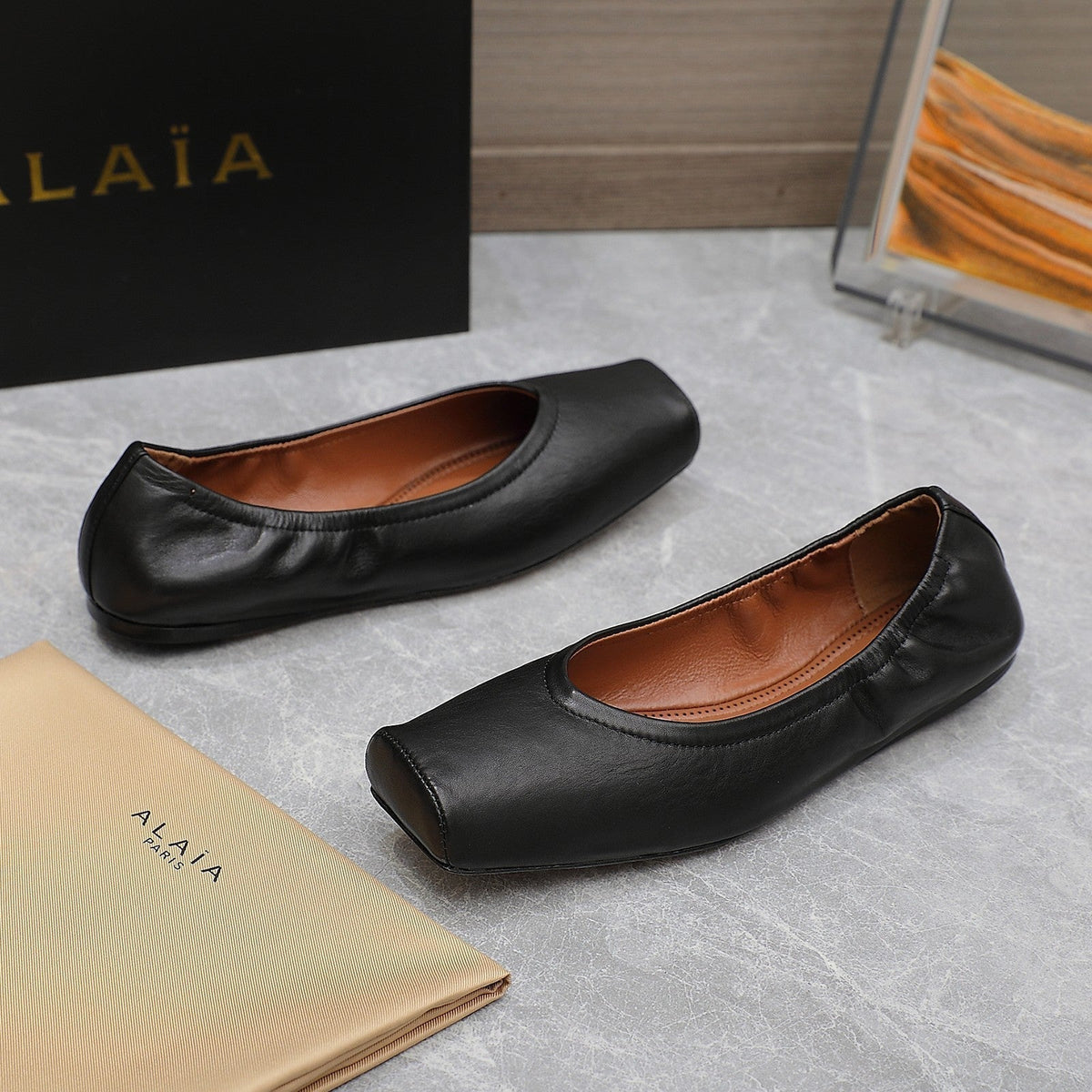 ALAIA BALLET FLATS IN BLACK SMOOTH CALFSKIN