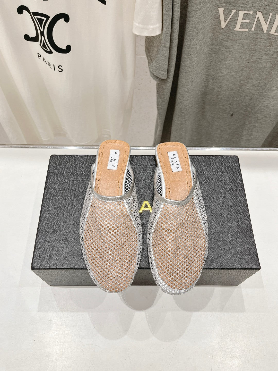 ALAIA FLAT MULES IN SILVER MESH FISHNET