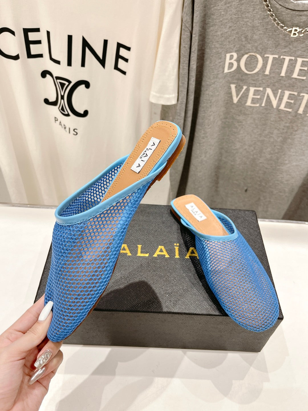ALAIA FLAT MULES IN CERULEAN BLUE MESH FISHNET