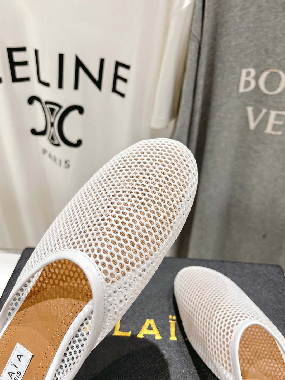 ALAIA FLAT MULES IN WHITE MESH FISHNET